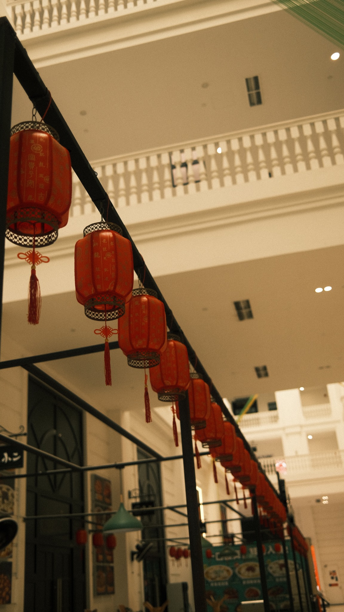 Red lanterns receding through an interior space